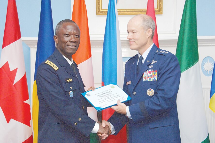 General de Brigade Marc Kodjo Aka (left), commandant of the Air Force, Côte d’Ivoire, accepts a certificate from Air University Commander Lt. Gen. Allen G. Peck as one of eight new inductees to the International Officer School’s Honor Roll. Seven of the eight new inductees attended a ceremony Oct. 8 that recognized the former AU students’ achievements in attaining “Chief of Staff of the Air Force” level or higher in their respective countries. (U.S. Air Force photo/Melanie Rodgers Cox)