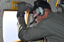 SOMEWHERE OVER BANGOR, Maine ? Air Force Reserve Staff Sgt. Kern Smith, a loadmaster assigned to the 773rd Airlift Squadron, looks through the troop door window of a C-130H tactical cargo transport aircraft during a flight to St. John?s, Canada, October 12. From St. John?s, Sergeant Smith and his fellow Reservists will fly to Prestwick, Scotland and eventually to Ramstein Air Base, Germany. While at Ramstein, the 910th Airmen, based at Youngstown Air Reserve Station, Ohio, will participate in Operation Joint Enterprise. The C-130 crews and maintainers supporting Joint Enterprise will work together to airlift cargo to locations in the U.S. Europe Command (EUROCOM) and the U.S. Africa Command (AFRICOM) Theaters of Operation. U.S. Air Force photo by Master Sgt. Bob Barko Jr. 