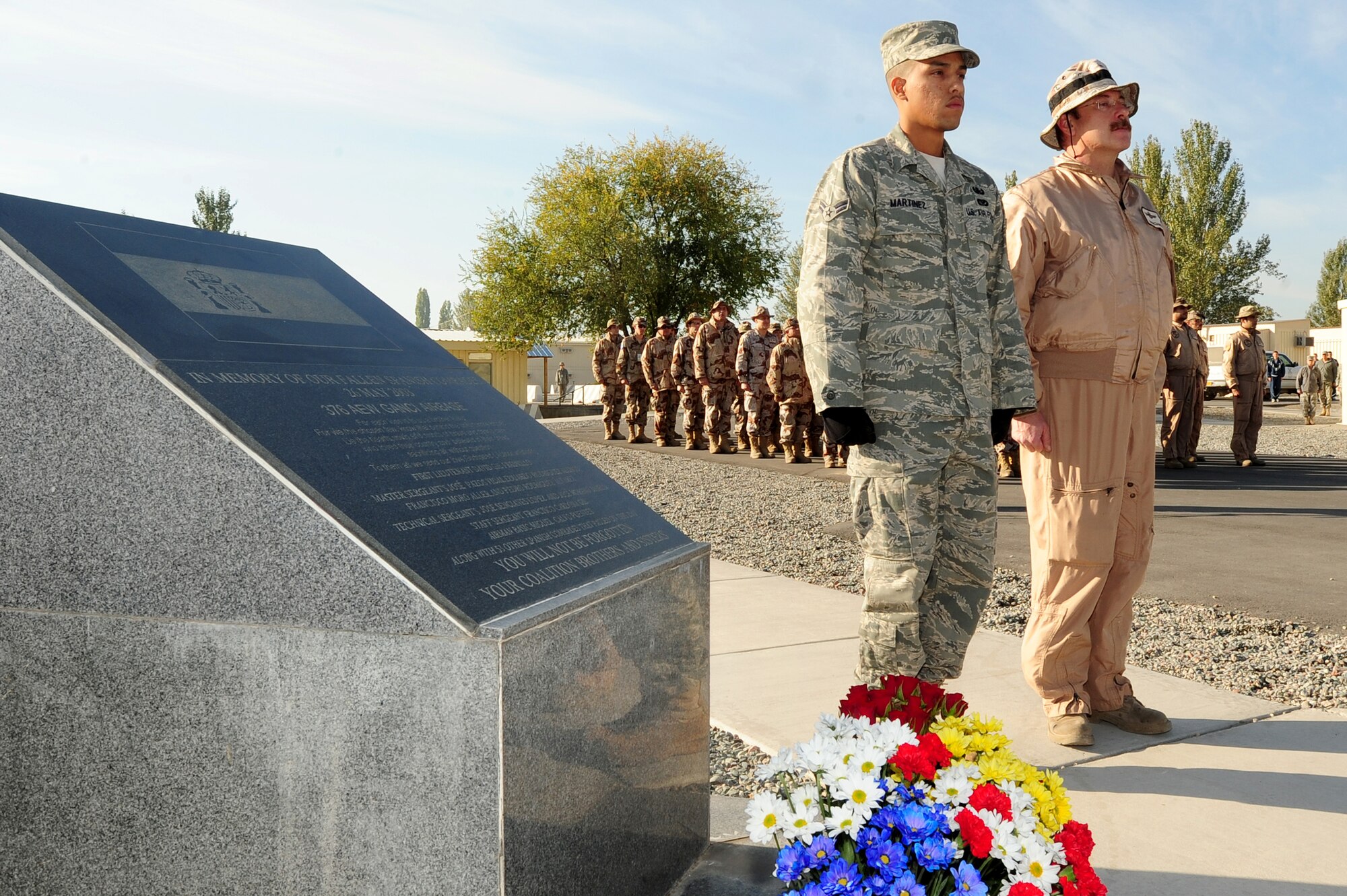 Flowers are placed by U.S. and Spanish servicemembers at a memorial Oct. 13, 2009, at the Transit Center at Manas, Kyrgyzstan. Airmen came together to remember those who lost their lives in battle in support of Operation Enduring Freedom. (U.S. Air Force photo/Senior Airman Steele C. G. Britton) 