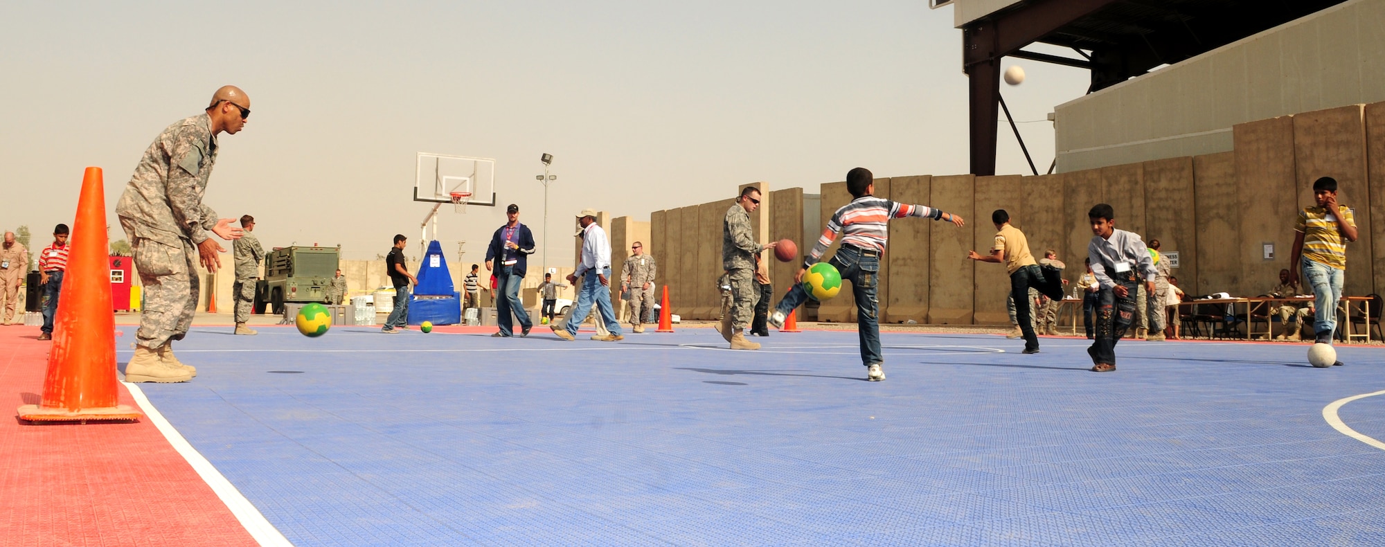 JOINT BASE BALAD, Iraq -- Servicemembers play sports with local children at the H-6 recreation center during Iraqi Kids Day here Oct. 10, 2009. (U.S. Air Force photo/Staff Sgt. Heather M. Norris)