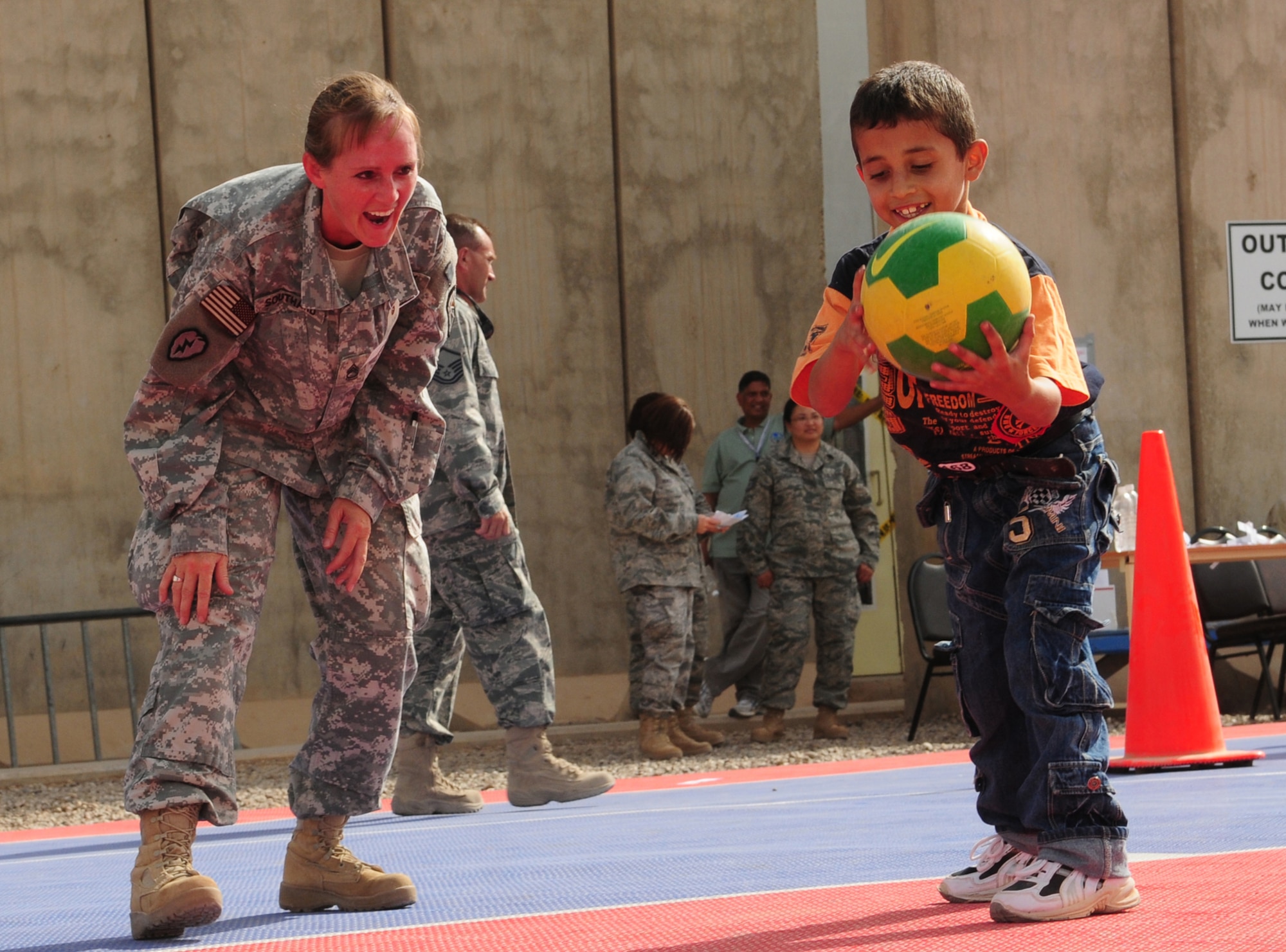 JOINT BASE BALAD, Iraq -- Sgt. 1st Class Diana Southard, 23rd Ordnance Headquarters platoon sergeant, plays basketball with an Iraqi child during the Iraqi Kids Day here Oct. 10, 2009. Sergeant Southard is a native of Medford, Ore. (U.S. Air Force photo/Staff Sgt. Heather M. Norris) 