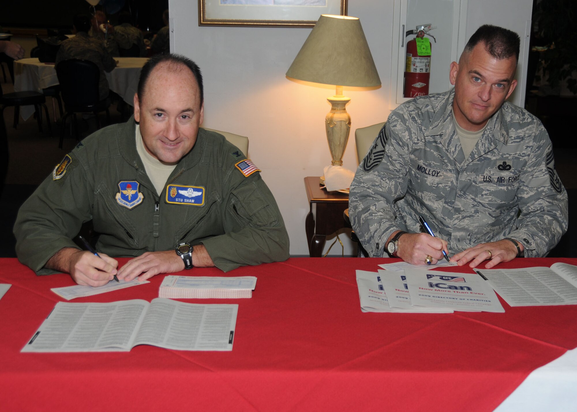 ALTUS AIR FORCE BASE, Okla. -- Col. Stuart Shaw, 97th Air Mobility Wing vice
commander, and Chief Master Sgt. Eric Molloy, 97 AMW command chief, sign
pledge cards for charities during the Combined Federal Campaign Kick Off
Luncheon at the Freedom Community Center Oct. 13. (U.S. Air Force photo/
Airman 1st Class Tiffany M. Deuel)
