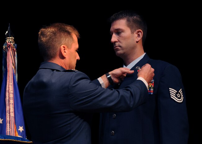 Tech. Sgt. Michael Williams is awarded the Bronze Star Medal with Valor by Col. John Wood at the Charleston AFB theater Oct. 15. The Bronze Star is awarded to service members for bravery, acts of merit or meritorious service and may be awarded with valor for courage under fire. Sergeant Williams is an explosive ordnance technician with the 437th Civil Engineer Squadron and Colonel Wood is the 437th Airlift Wing commander. (U.S. Air Force photo/Senior Airman Katie Gieratz)