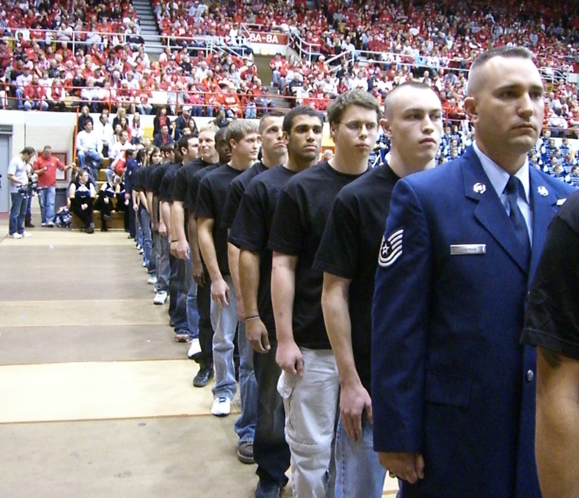 WRIGHT-PATTERSON AIR FORCE BASE, Ohio – More than 13,000 Ohio State University fans witnessed a mass enlistment ceremony for 42 new enlistees coming into the Air Force Reserves and current reservists assigned to the 445th Airlift Wing during the pre-game OSU vs. Wisconsin “skull session” at the St. John Arena in Columbus, Ohio, Oct. 10. Those re-enlisting from the wing included; Master Sgt. Phillip Finnegan, 87th Aerial Port Squadron; Master Sgt. Mark O’Connell, 445th Aerospace Medicine Squadron; Tech. Sgt. James Brown, 445th Aircraft Maintenance Squadron; and Tech. Sgt. Nathan Lowman, 445th Maintenance Operations Flight. (U. S. Air Force photo/Senior Airman Matthew Cook)