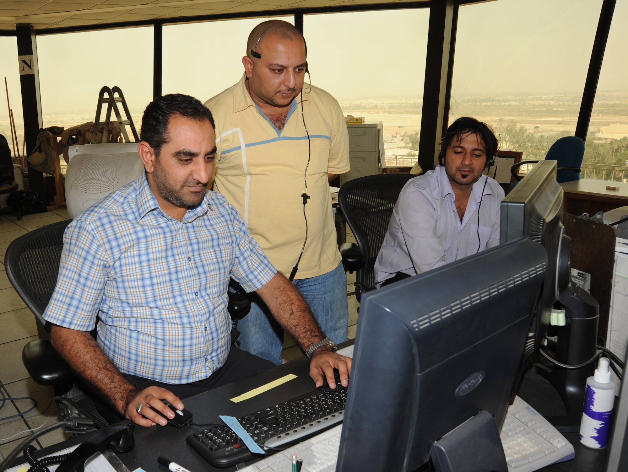 BAGHDAD -- Ali Thamer (center), Baghdad International Airport tower manager, observes fully qualified and licensed Iraqi air traffic controllers manage traffic in the airspace here Oct. 14, 2009. Air traffic control operations were conducted by Iraqis and U.S. Airmen assigned to the 447th Expeditionary Operations Support Squadron at Sather Air Base, while more Iraqis trained with the Washington Consulting Group, an American contracted company. Airmen were able to fully turn over air traffic control duties to the Iraqis as of Oct.1. (U.S. Air Force photo/Tech. Sgt. Johnny L. Saldivar)