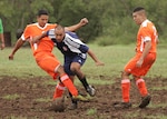 Warhawk Joel Lobisser tries to control the ball among two Seymour-Johnson defenders during the teams' first game at the League Executive San Antonio soccer fields. (U.S. Air Force photo/Robbin Cresswell)