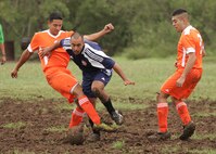 Warhawk Joel Lobisser tries to control the ball among two Seymour-Johnson defenders during the teams' first game at the League Executive San Antonio soccer fields. (U.S. Air Force photo/Robbin Cresswell)