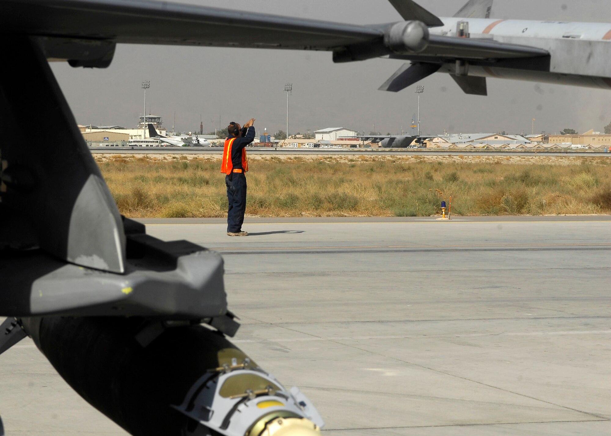 BAGRAM AIRFIELD, Afghanistan -- A member of the 79th Expeditionary Fighter Squadron marshals an F-16 Fighting Falcon to receive a post-flight inspection, Oct. 16, 2009.  The aircraft receives inspections before takeoff and after landing to ensure the safety of the aircraft and pilot.  The unit, known as the Tigers, performs tactical air-to-air and air-to-ground support while supporting Operation Enduring Freedom.  (U.S. Air Force photo/Senior Airman Felicia Juenke)