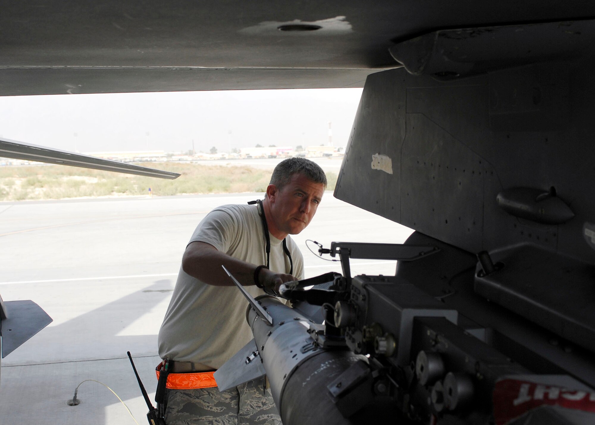 BAGRAM AIRFIELD, Afghanistan -- Technical Sgt. Jim Frey, a weapon expediter from the 79th Aircraft Maintenance Unit, performs an inspection of bombs on an F-16 Fighting Falcon here, Oct. 16, 2009.  Weapon expediters inspect the aircraft and bombs to ensure the aircraft is safe for the pilot.  Sergeant Frey is deployed from Shaw Air Force Base, S.C., and hails from Lock Haven, Pa.  (U.S. Air Force photo/Senior Airman Felicia Juenke)