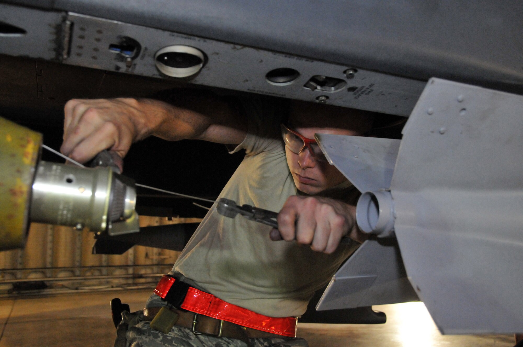 Senior Airman Derrick Pennington, weapons load crew member, secures a Mark 82 onto an F-15 at Kunsan Air Base, Republic of Korea, Sept. 17. Airman Pennington is assigned to the 389th Expeditionary Fighter Squadron, deployed from Mountain Home Air Force Base, Idaho. Throughout the week, 389th EFS weapons loaders like Airman Pennington, along with other Airmen and pilots, trained with live munitions. (U.S. Air Force photo/Capt. Shannon Collins) 
