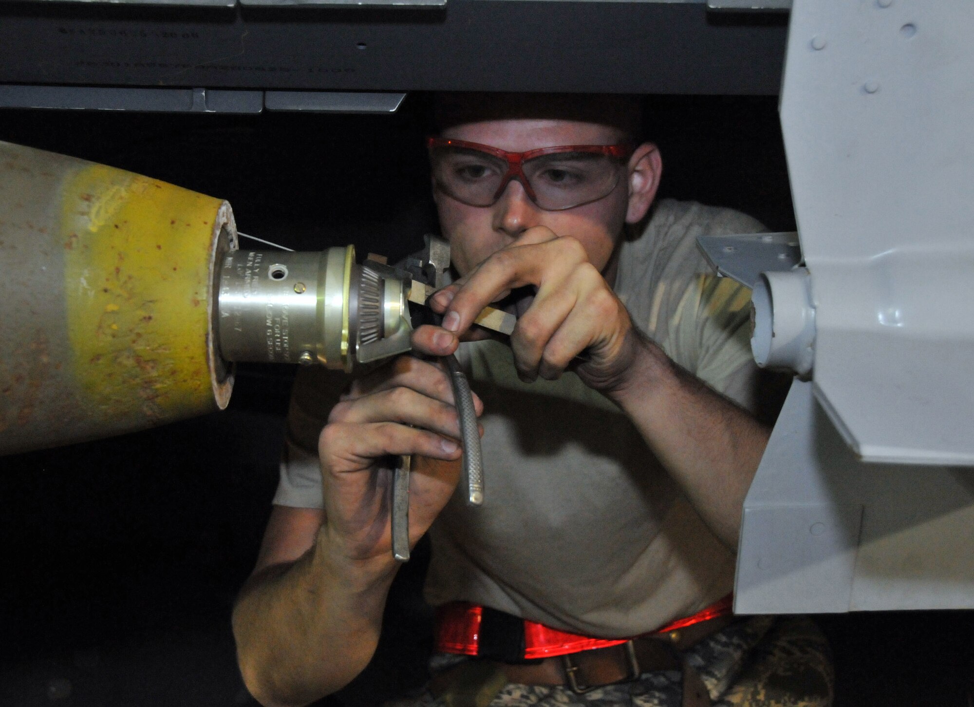 Senior Airman Derrick Pennington, weapons load crew member, secures a Mark 82 onto an F-15 at Kunsan Air Base, Republic of Korea, Sept. 17. Airman Pennington is assigned to the 389th Expeditionary Fighter Squadron, deployed from Mountain Home Air Force Base, Idaho. Throughout the week, 389th EFS weapons loaders like Airman Pennington, along with other Airmen and pilots, trained with live munitions. (U.S. Air Force photo/Capt. Shannon Collins) 