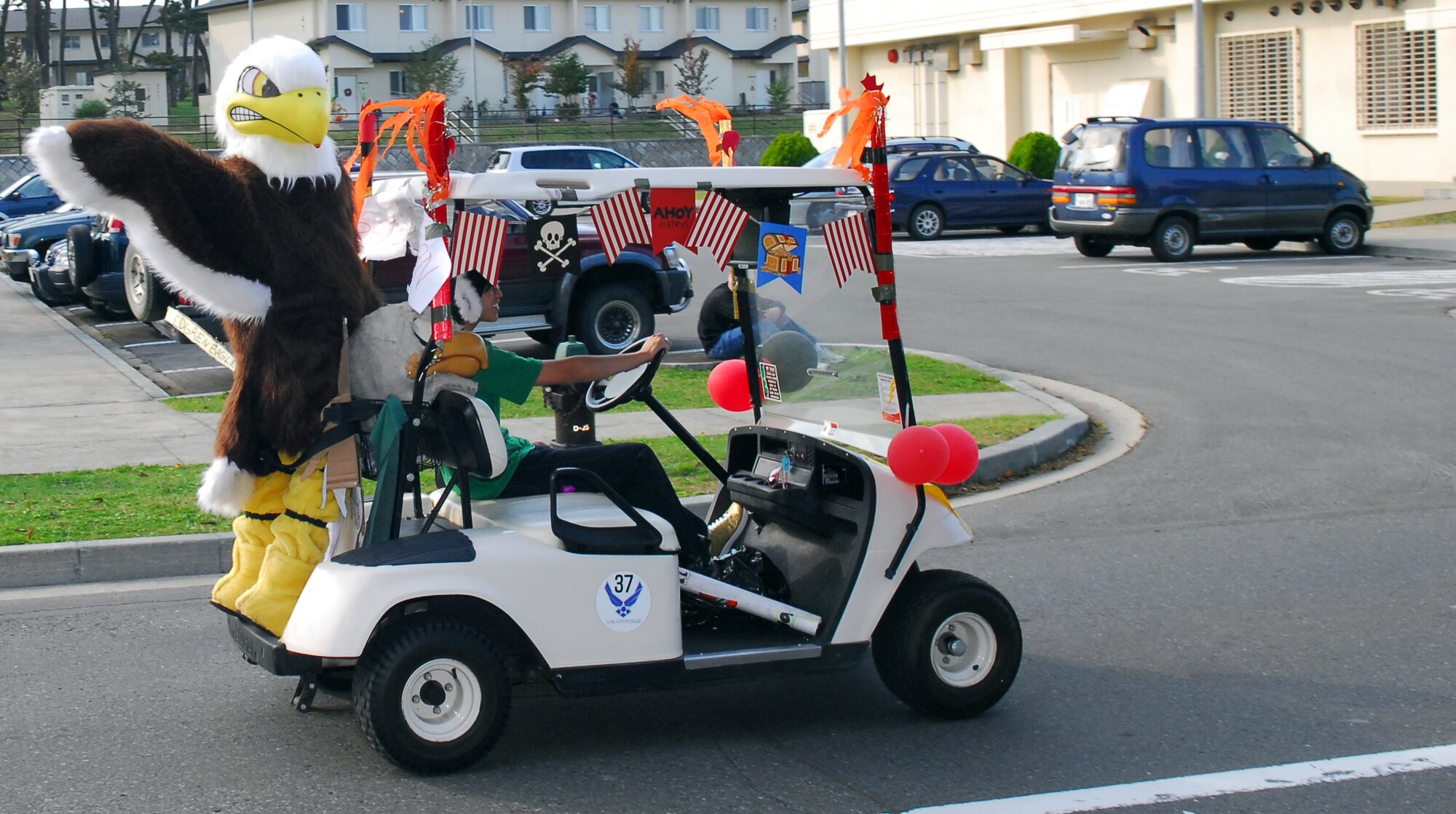 MISAWA AIR BASE, Japan – Ms. Lori Grant, an Edgren High School teacher, chauffer’s Eddie the Eagle, Edgren’s mascot, Oct. 16, during the school’s homecoming parade. The identity of Eddie the Eagle is a closely guarded secret of Edgren’s faculty, and his name will not be revealed until the end of Homecoming. (U.S. Air Force photo/Staff Sgt. Phillip Butterfield)