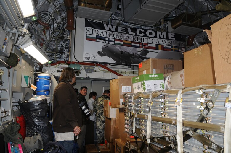 Local civic leaders, base personnel and their families tour a C-17 Globemaster III following its arrival Oct. 12, 2009 to Papa Air Base, Hungary. This is the third and final aircraft that will be operated by the Heavy Airlift Wing. The wing’s purpose is to collectively create a heavy airlift solution with global reach to meet national obligations to the European Union, NATO and U.N. (U.S. Air Force photo/Staff Sgt. Mercedes Crossland)