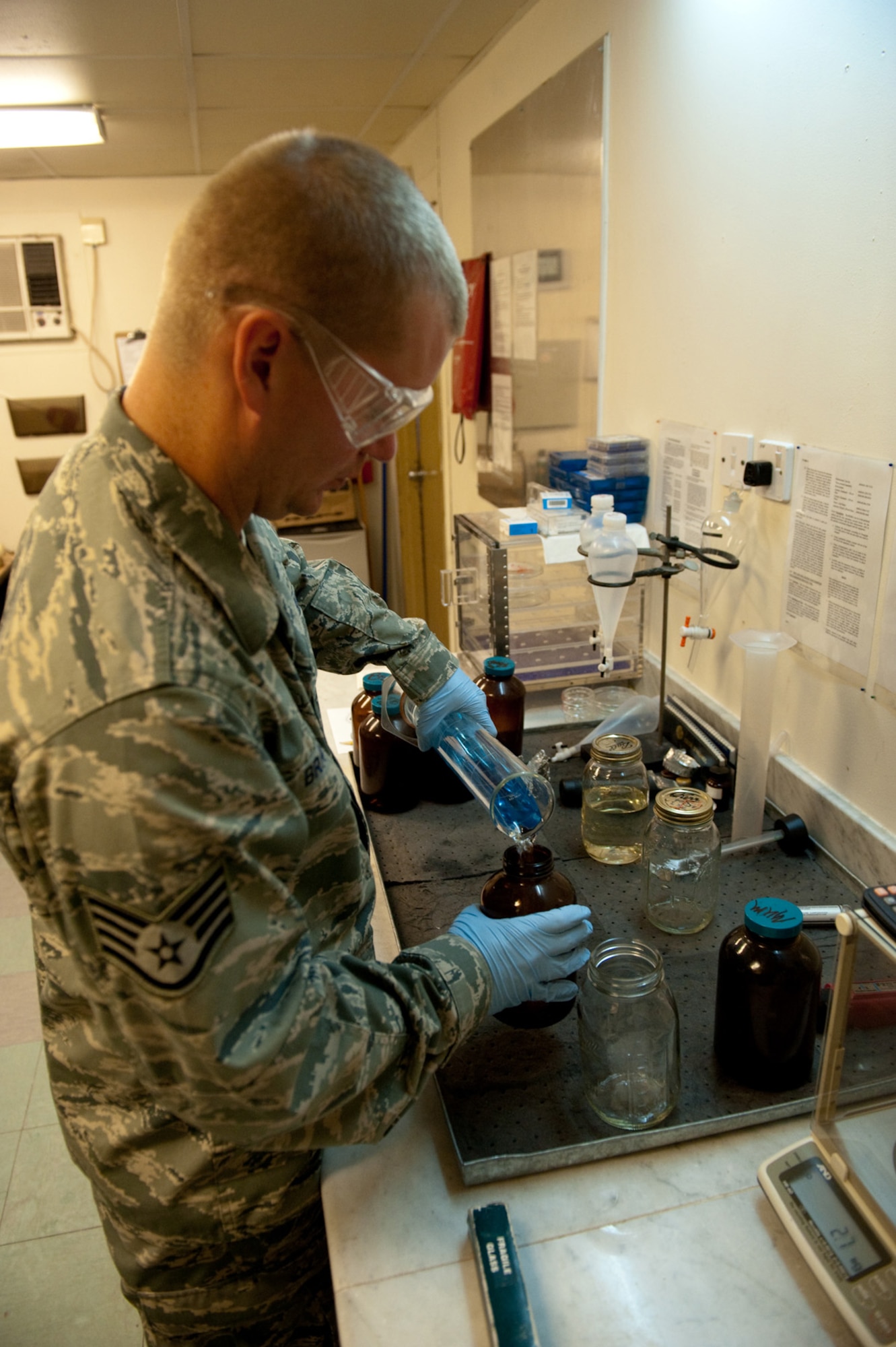 Staff Sgt. Michael Brady, 379th Expeditionary Logistics Readiness Squadron fuels laboratory NCOIC, performs an API gravity determination test on aviation gasoline, Oct. 14, 2009, in Southwest Asia. The fuels laboratory ensures all fuel received meets Air Force standards from reception to use by local aircraft or ground vehicles. Sergeant Brady is deployed from Dyess Air Force Base, Texas in support of operations Iraqi Freedom and Enduring Freedom. (U.S. Air Force photo/Staff Sgt. Robert Barney) 