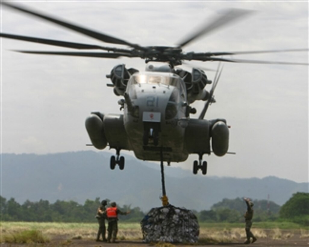 U.S. Marines from the 31st Marine Expeditionary Unit attach a pallet of construction supplies to a CH-53E Super Stallion helicopter in Padang, Indonesia, on Oct. 10, 2009.  The supplies are destined for remote areas of West Sumatra, Indonesia, following two earthquakes.  Amphibious Force 7th Fleet is directing the U.S. military response to a request by the Indonesian government for assistance and support for humanitarian efforts.  