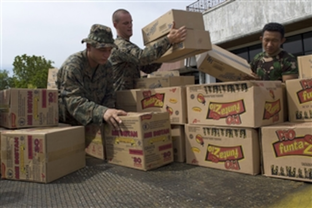 U.S. Marines assigned to the Combat Logistics Battalion 31, 31st Marine Expeditionary Unit, and Indonesian air force personnel load a pallet of food destined for remote areas of West Sumatra, Indonesia, on Oct. 11, 2009.  Amphibious Force 7th Fleet is directing the U.S. military response after a request by the Indonesian government for assistance and support for humanitarian efforts following earthquakes and landslides.  