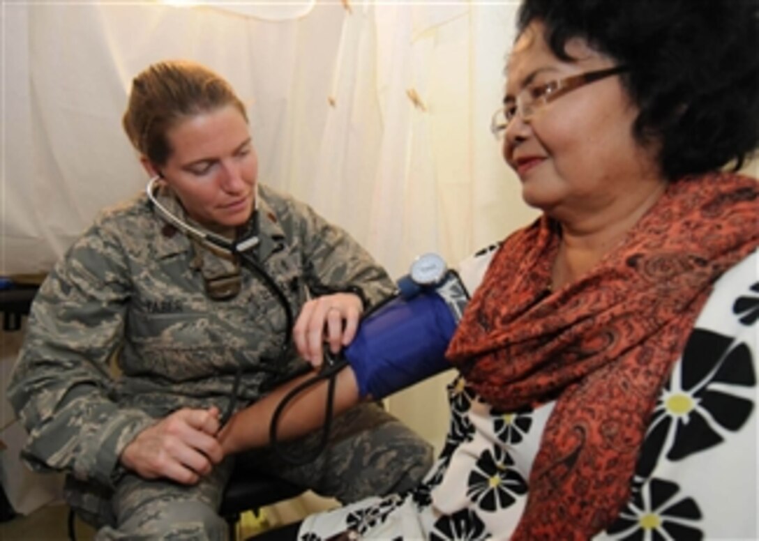 U.S. Air Force Maj. Shannon Faber checks a patient's blood pressure during a medical assessment at a mobile field hospital in Padang, Indonesia, on Oct. 8, 2009.  Faber is an emergency medical doctor from the 3rd Medical Operations Squadron at Elmendorf Air Force Base, Alaska, deployed with an Air Force humanitarian assistance rapid response team.  