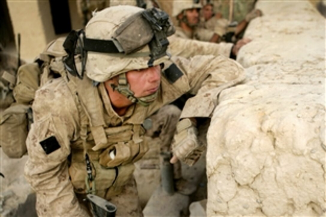 U.S. Marines observe the movement of enemy forces during an attack on Patrol Base Bracha in the Garmsir district of Helmand province, Afghanistan, Oct. 9, 2009.  The Marines are deployed with Regimental Combat Team 3, whose mission is to conduct counterinsurgency operations in partnership with Afghan security forces in southern Afghanistan.