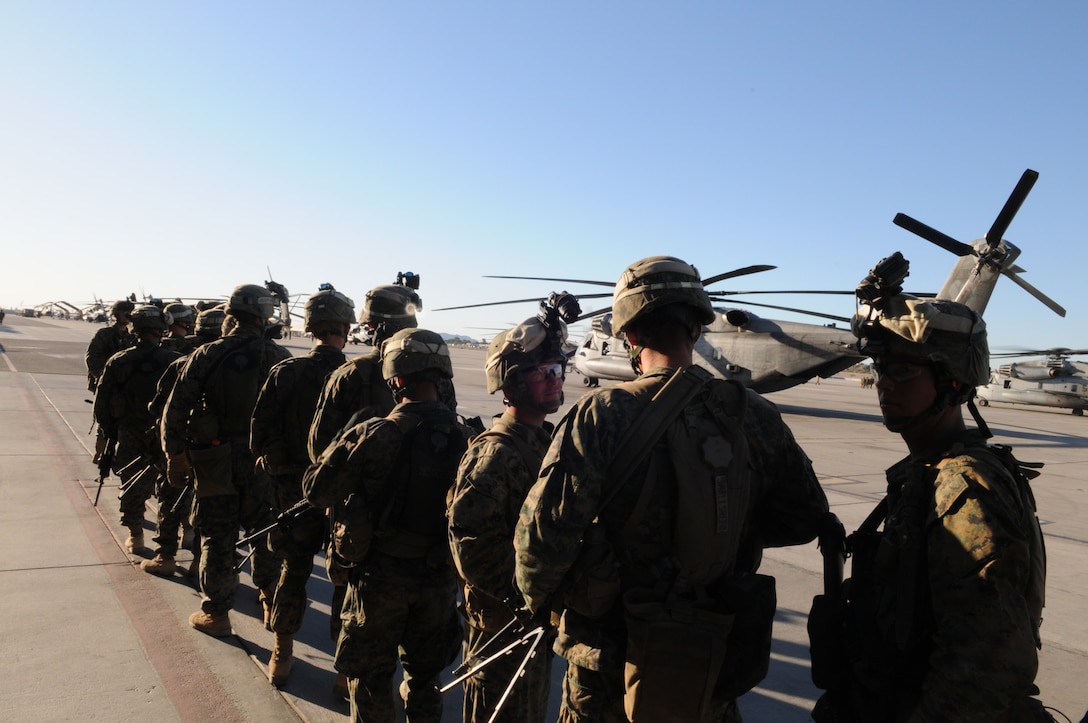Marines from Company A, 1st Battalion, 2nd Marine Regiment, line up on the flight line at the Marine Corps Air Station in Yuma, Ariz., before boarding a CH-53 helicopter for a long-distance night helicopter raid exercise Oct. 16, 2009. The company took off from Yuma in six CH-53s and two MV-22 Ospreys to seize an airfield and rescue an enemy defector and his family, as well as retrieve valuable communication equipment, at Fort Huachuca near Tucson, Ariz. The training was in preparation for the battalion’s upcoming deployment to Afghanistan in the spring of 2010.