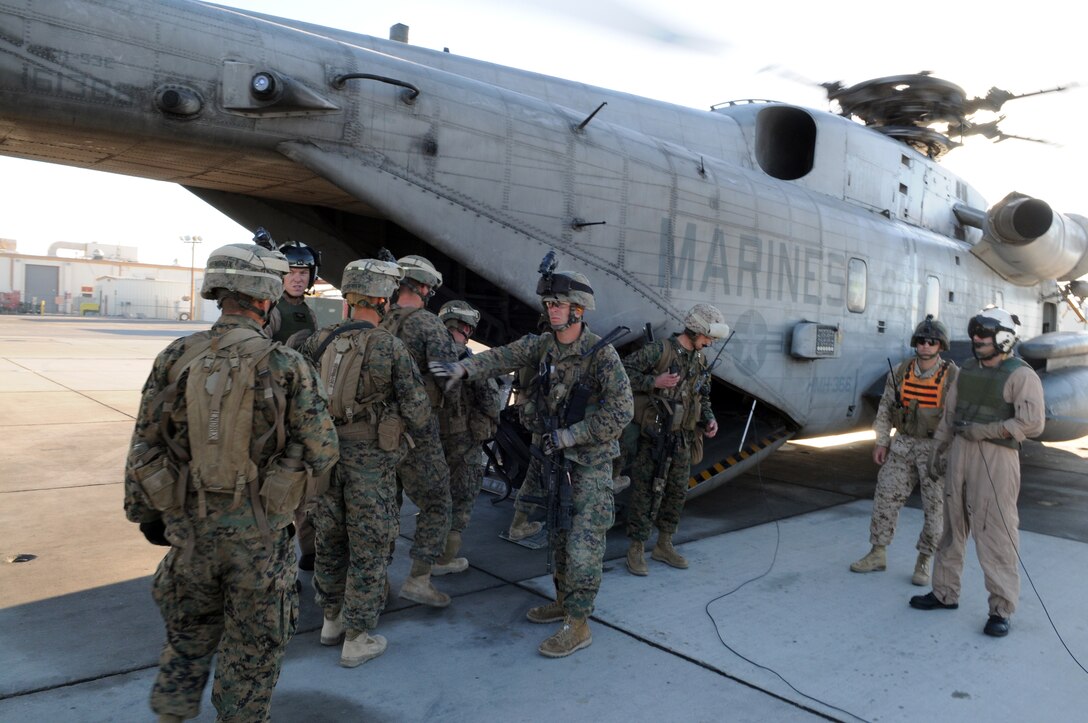 Marines from Company A, 1st Battalion, 2nd Marine Regiment, board a CH-53 helicopter on the flight line at the Marine Corps Air Station in Yuma, Ariz., for a long-distance night helicopter raid exercise Oct. 16, 2009. The company took off from Yuma in six CH-53s and two MV-22 Ospreys to seize an airfield and rescue an enemy defector and his family, as well as retrieve valuable communication equipment, at Fort Huachuca near Tucson, Ariz. The training was in preparation for the battalion’s upcoming deployment to Afghanistan in the spring of 2010.