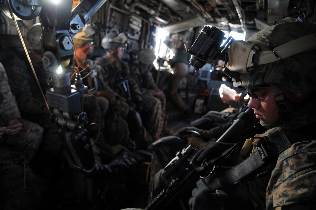 Marines from Company A, 1st Battalion, 2nd Marine Regiment, ride aboard a CH-53 helicopter after taking off from the flight line at the Marine Corps Air Station in Yuma, Ariz., for a long-distance night helicopter raid exercise Oct. 16, 2009. The company took off from Yuma in six CH-53s and two MV-22 Ospreys to seize an airfield and rescue an enemy defector and his family, as well as retrieve valuable communication equipment, at Fort Huachuca near Tucson, Ariz. The training was in preparation for the battalion’s upcoming deployment to Afghanistan in the spring of 2010.