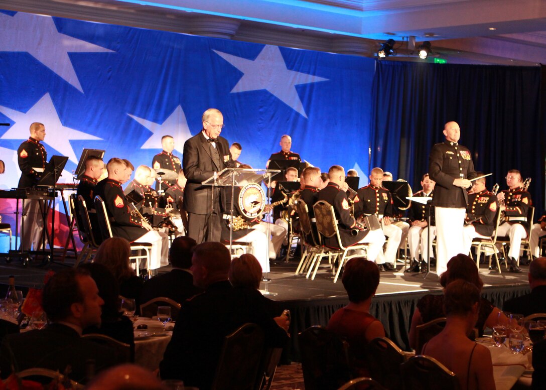 The master of ceremony annonuces the 1st Marine Division band with Cheif Warrant Officer 4 Michael W. Edmonson, band officer, at the 27th annual Marine Coprs Scholarship Foundation at the St. Regis Monarch Beach Resort, Dana Point, Calif., Oct. 17.