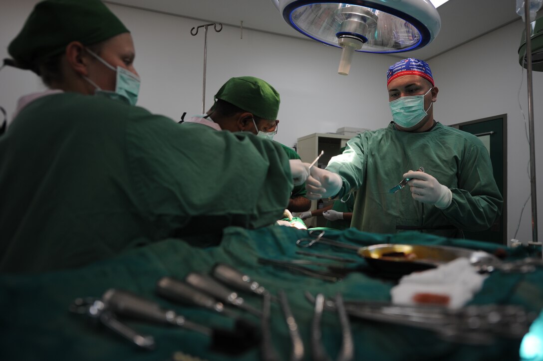 Petty Officer 2nd Class Rachel Arndt, from Wauwatosa, Wis., assists Navy Lt. Billy Turley, from Auburn, Ky., during surgery on a 4-year-old boy at the Santa Rosa Hospital here Oct. 17. Arndt and Turley are part of a medical team from the 11th Marine Expeditionary Unit that has provided medical and dental care at numerous locations in Timor Leste since Oct. 14.