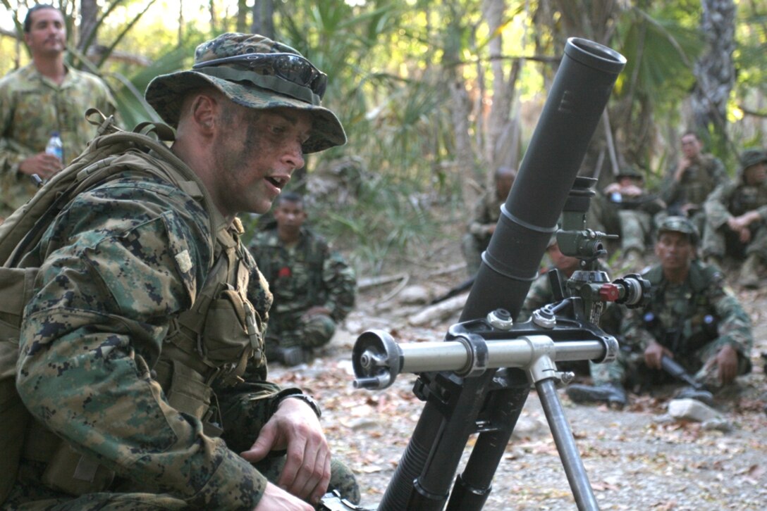 Lance Cpl. Ian Wiseman, a mortarman with Company E, Battalion Landing Team 2/4, teaches members of the Timor Leste Defense Force and Australian soldiers with the International Stabilization Force (ISF) how to operate the 60mm mortar system during a training exercise Oct. 17. Members of the 11th Marine Expeditionary Unit trained with Timor Leste and Australian soldiers during an exercise focused on promoting theater cooperation through civic action projects and military interaction.