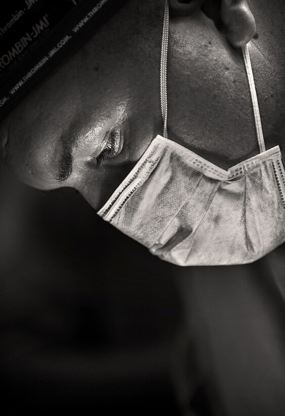 Navy Lt. Billy Turley, from Auburn, Ky., performs surgery on a 4-year-old boy at the Santa Rosa Hospital in Oecussi, Timor Leste, Oct. 17. Turley, a general dentist with the 11th Marine Expeditionary Unit, extracted seven decayed teeth and drained an infection during the procedure.