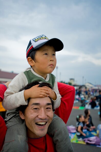 MISAWA AIR BASE, Japan -- A father and son watch a Japan Air Self-Defense Force F-2 demonstration during the Misawa Air Fest 2009 Oct. 18. (U.S. Air Force photo/Senior Airman Jamal D. Sutter)