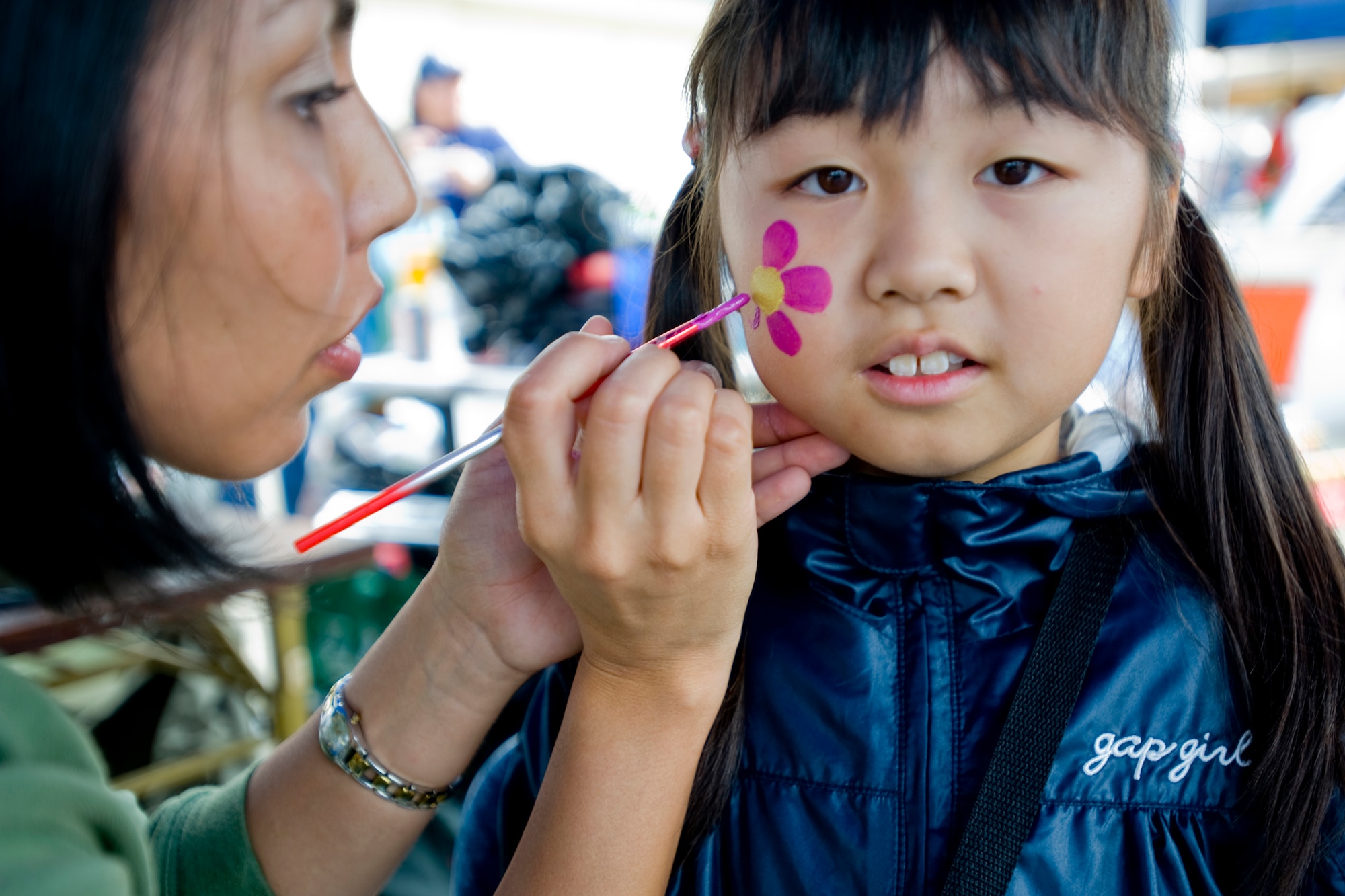 MISAWA AIR BASE, Japan -- Paulette Franco, wife of Staff Sgt. Franklin Franco, 35th Security Forces Squadron, paints a design on a young girl's face during the Misawa Air Fest 2009 Oct. 18. (U.S. Air Force photo/Senior Airman Jamal D. Sutter)