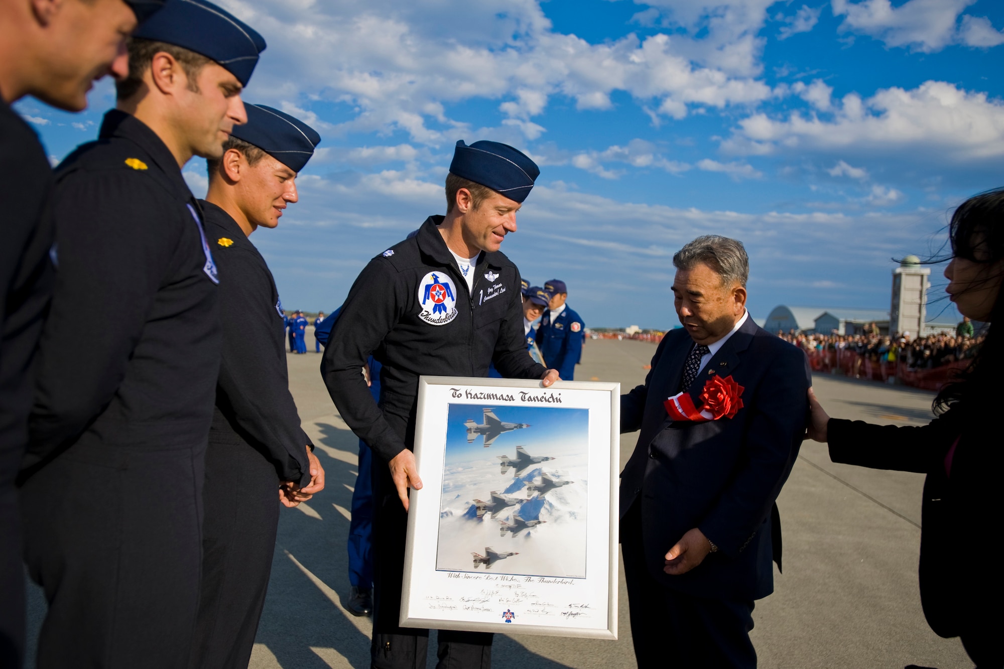 MISAWA AIR BASE, Japan -- Members of the U.S. Air Force Thunderbirds demonstration team present a signed lithograph to Misawa City Mayor Kazumasa Taneichi during the Misawa Air Fest 2009 Oct. 18. The crew thanked the mayor for allowing them to perform at Misawa. (U.S. Air Force photo/Senior Airman Jamal D. Sutter)