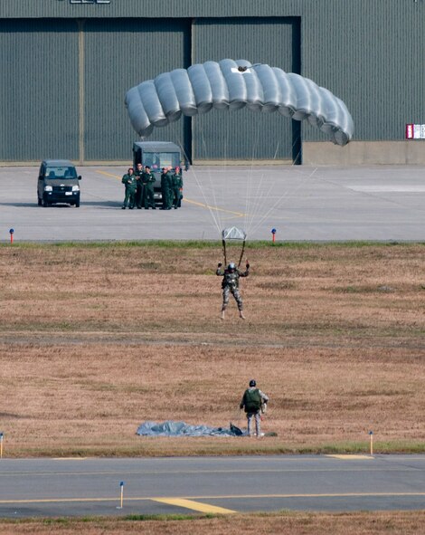 MISAWA AIR BASE, Japan -- SERE specialists parachute on to the flightline after a free-fall jump from a C-130 Hercules during Air Fest 2009 Oct. 18. (U.S. Air Force photo/Staff Sgt. Samuel Morse)