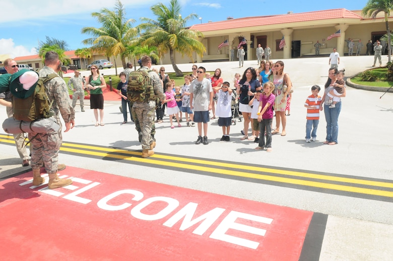 ANDERSEN AFB, GUAM - The families of members of the HARRT Team greet them as they arrive, Oct. 18 here . The HARRT Team, consisting of 70 personnel members, deployed to Indonesia on Oct. 5 and treated over 1,900 patients before returning. (U.S. Air Force Photo by Airman 1st Class Julian North)