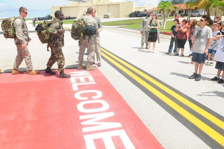 ANDERSEN AFB, GUAM - The families of members of the HARRT Team greet them as they arrive, Oct. 18 here . The HARRT Team, consisting of 70 personnel members, deployed to Indonesia on Oct. 5 and treated over 1,900 patients before returning. (U.S. Air Force Photo by Airman 1st Class Julian North)