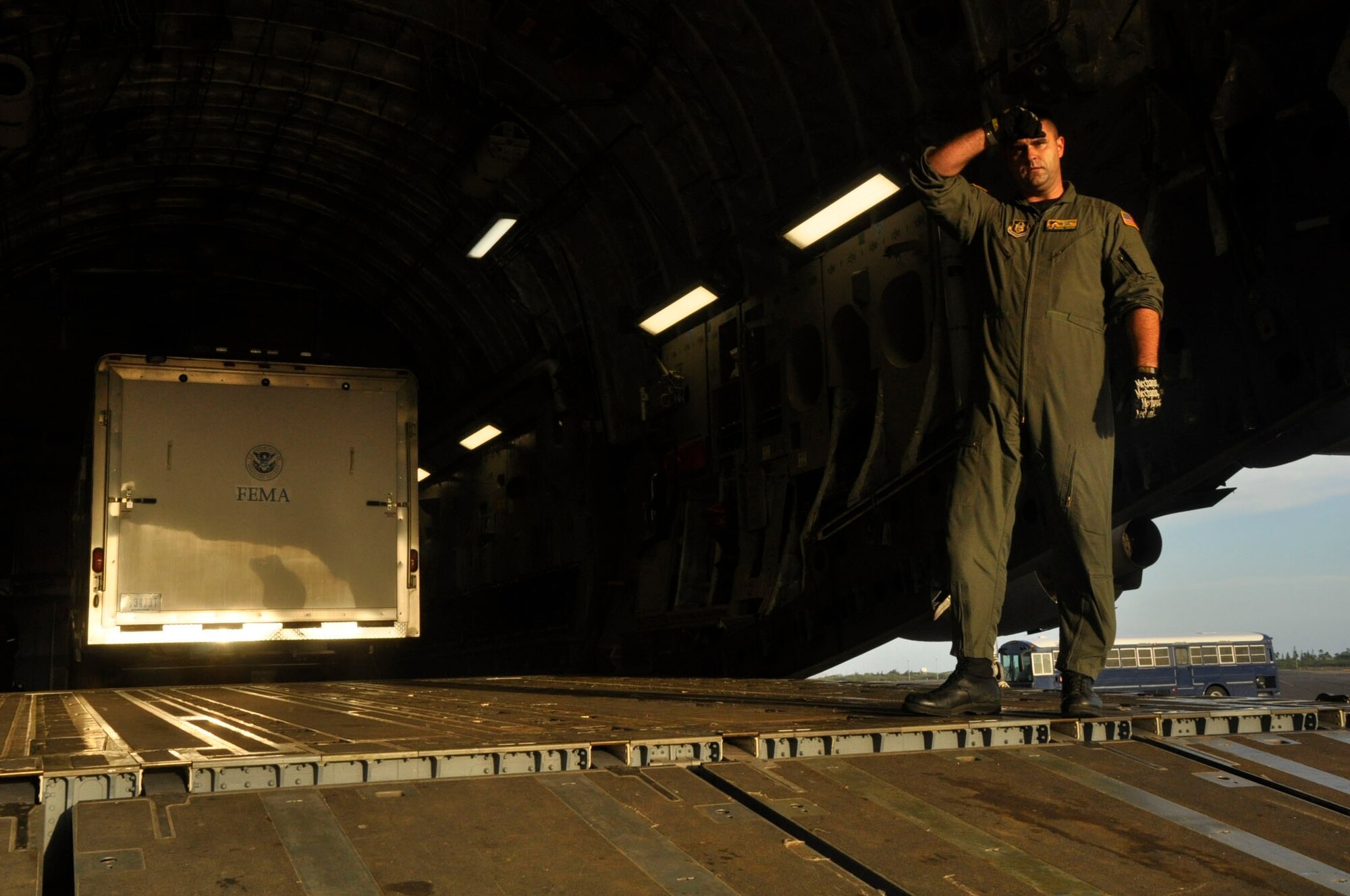 Help for American Somoa: Aircrew and FEMA members off-load supplies and equipment from the back of a 729th Airlift Squadron C-17 at Hickam AFB in Hawaii. The C-17 flew from March ARB to Dobbins ARB, Ga., Oct. 2, where 16 members of FEMA and a FEMA truck and communications trailer were boarded and flown to Hickam AFB as part of the humanitarian support mission after an earthquake and tsunami devastated the region. After Hickam, the C-17 flew three FEMA passengers and five generators to Pago Pago. On the return flight, the March aircraft carried Army National Guard Soldiers, first responders and Anthony M. Babauta, U.S. Assistant Secretary of the Interior for Insular Areas. March remained on alert for further tsunami relief missions from Oct. 1-6. (U.S. Air Force Photo/ Master Sgt. Daniel Nathaniel III)