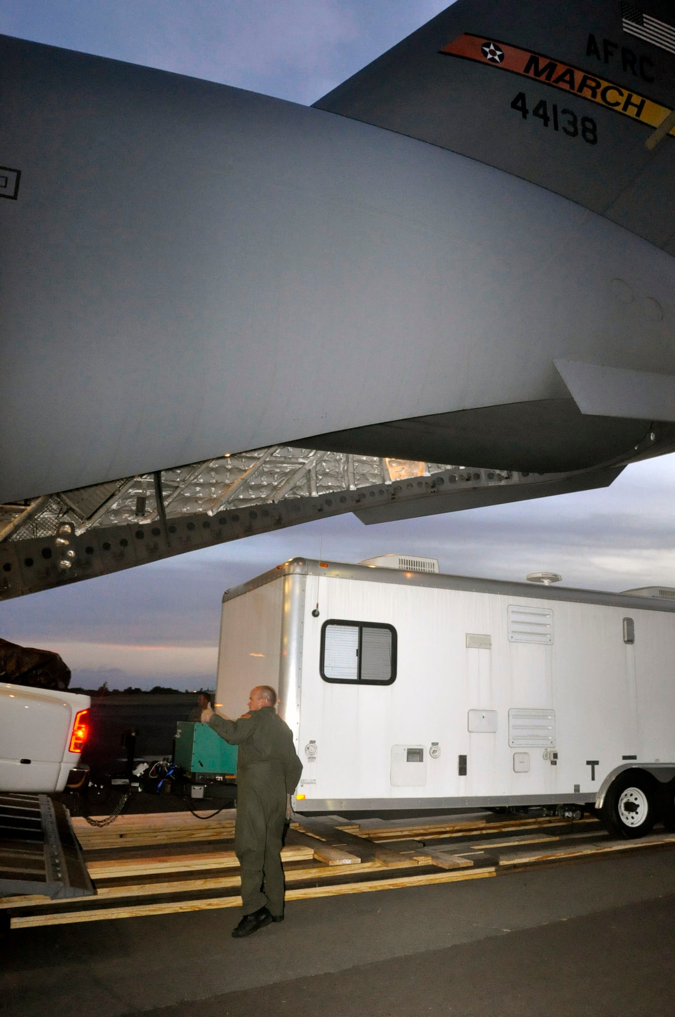 Help for American Somoa: Aircrew and FEMA members off-load supplies and equipment from the back of a 729th Airlift Squadron C-17 at Hickam AFB in Hawaii. The C-17 flew from March ARB to Dobbins ARB, Ga., Oct. 2, where 16 members of FEMA and a FEMA truck and communications trailer were boarded and flown to Hickam AFB as part of the humanitarian support mission after an earthquake and tsunami devastated the region. After Hickam, the C-17 flew three FEMA passengers and five generators to Pago Pago. On the return flight, the March aircraft carried Army National Guard Soldiers, first responders and Anthony M. Babauta, U.S. Assistant Secretary of the Interior for Insular Areas. March remained on alert for further tsunami relief missions from Oct. 1-6. (U.S. Air Force Photo/ Master Sgt. Daniel Nathaniel III)