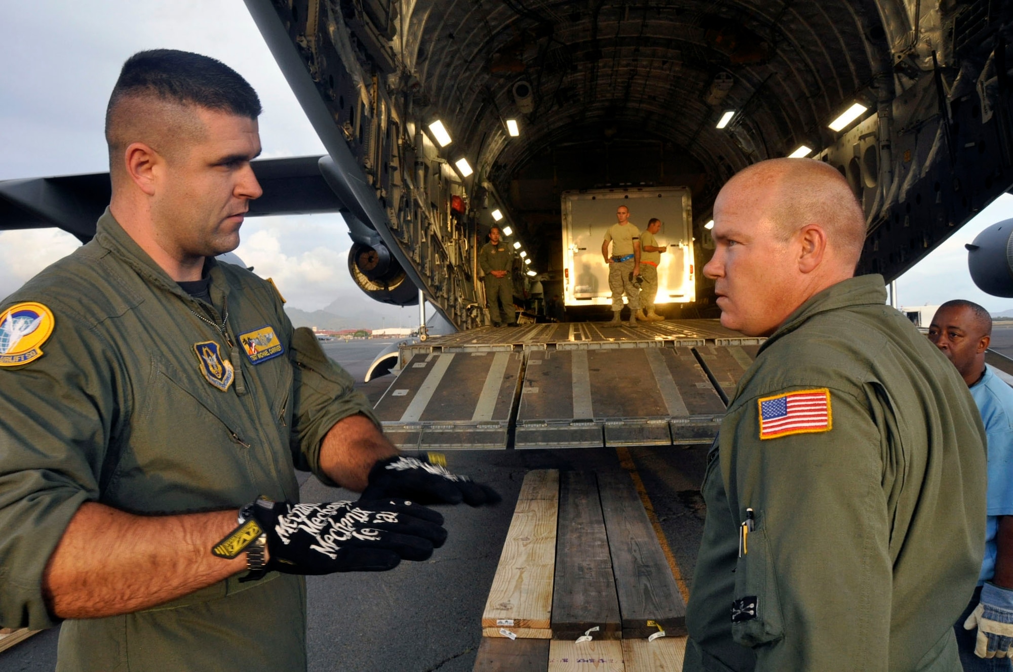 Help for American Somoa: Aircrew and FEMA members off-load supplies and equipment from the back of a 729th Airlift Squadron C-17 at Hickam AFB in Hawaii. The C-17 flew from March ARB to Dobbins ARB, Ga., Oct. 2, where 16 members of FEMA and a FEMA truck and communications trailer were boarded and flown to Hickam AFB as part of the humanitarian support mission after an earthquake and tsunami devastated the region. After Hickam, the C-17 flew three FEMA passengers and five generators to Pago Pago. On the return flight, the March aircraft carried Army National Guard Soldiers, first responders and Anthony M. Babauta, U.S. Assistant Secretary of the Interior for Insular Areas. March remained on alert for further tsunami relief missions from Oct. 1-6. (U.S. Air Force Photo/ Master Sgt. Daniel Nathaniel III)