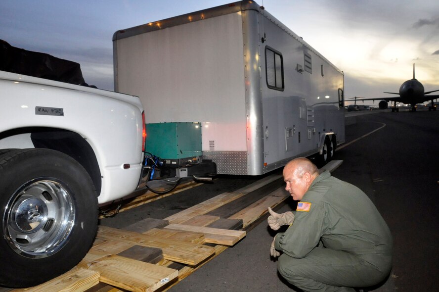 Help for American Somoa: Aircrew and FEMA members off-load supplies and equipment from the back of a 729th Airlift Squadron C-17 at Hickam AFB in Hawaii. The C-17 flew from March ARB to Dobbins ARB, Ga., Oct. 2, where 16 members of FEMA and a FEMA truck and communications trailer were boarded and flown to Hickam AFB as part of the humanitarian support mission after an earthquake and tsunami devastated the region. After Hickam, the C-17 flew three FEMA passengers and five generators to Pago Pago. On the return flight, the March aircraft carried Army National Guard Soldiers, first responders and Anthony M. Babauta, U.S. Assistant Secretary of the Interior for Insular Areas. March remained on alert for further tsunami relief missions from Oct. 1-6. (U.S. Air Force Photo/ Master Sgt. Daniel Nathaniel III)