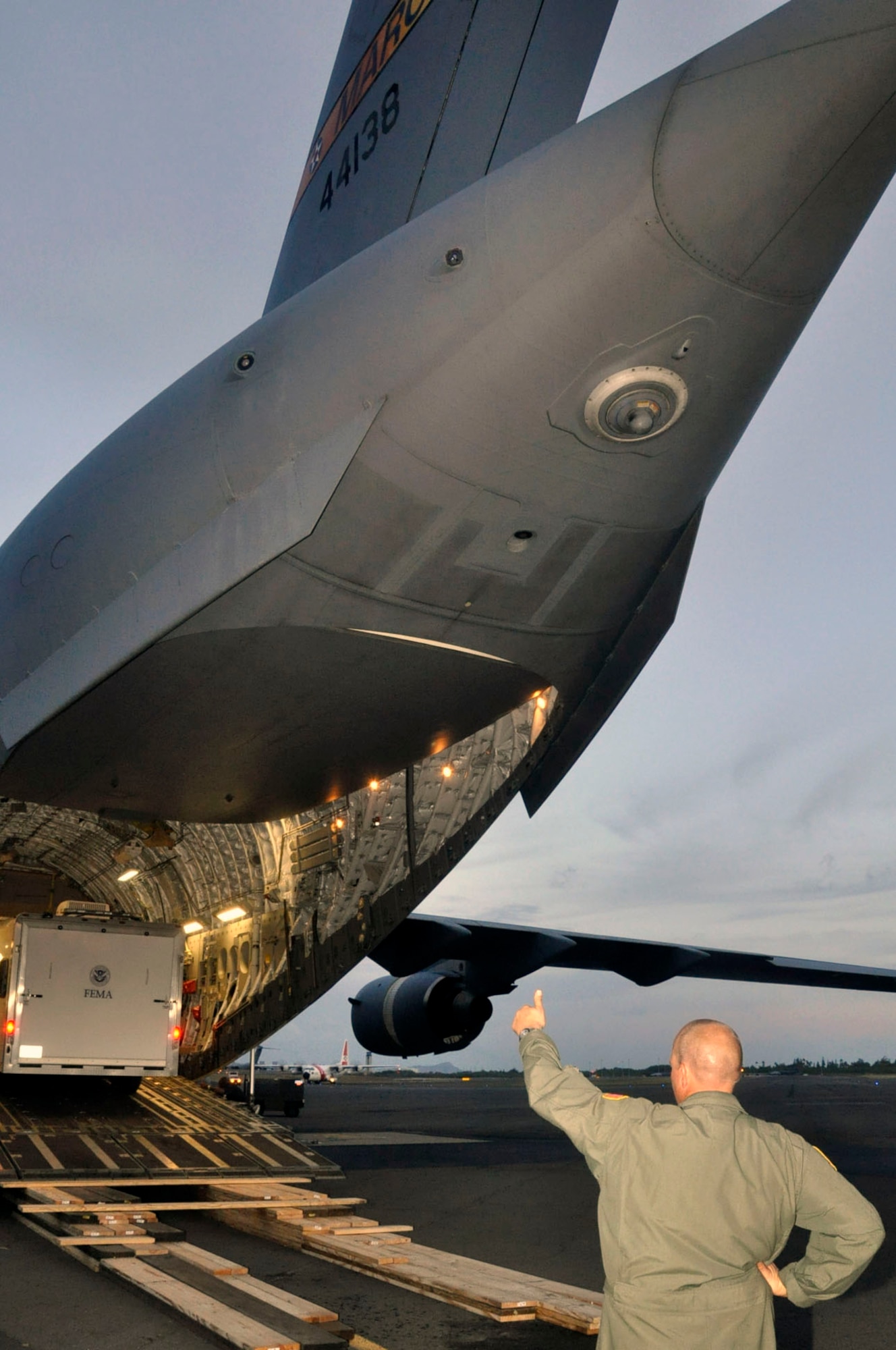 Help for American Somoa: Aircrew and FEMA members off-load supplies and equipment from the back of a 729th Airlift Squadron C-17 at Hickam AFB in Hawaii. The C-17 flew from March ARB to Dobbins ARB, Ga., Oct. 2, where 16 members of FEMA and a FEMA truck and communications trailer were boarded and flown to Hickam AFB as part of the humanitarian support mission after an earthquake and tsunami devastated the region. After Hickam, the C-17 flew three FEMA passengers and five generators to Pago Pago. On the return flight, the March aircraft carried Army National Guard Soldiers, first responders and Anthony M. Babauta, U.S. Assistant Secretary of the Interior for Insular Areas. March remained on alert for further tsunami relief missions from Oct. 1-6. (U.S. Air Force Photo/ Master Sgt. Daniel Nathaniel III)