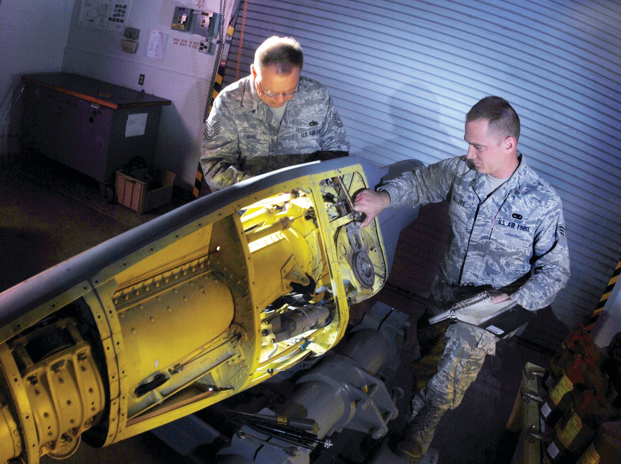 Tech. Sgt. Gary Evans (left) and Senior Airman Jack Sellers check the refueling boom assembly of a KC-135 Stratotanker aircraft during mid-cycle inspection at March ARB, Oct. 5. The Airmen are part of the 452nd Maintenance Squadron’s aircraft pneudraulics systems shop. (U.S. Air Force Photos by Val Gempis)