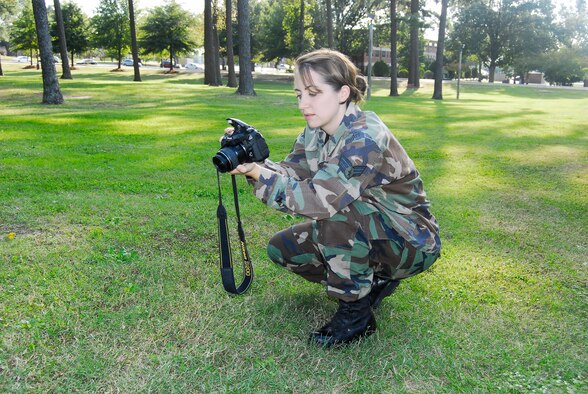 Senior Airman Mindy Bloem, 43rd Airlift Wing Public Affairs, prepares to take a photo Oct. 14 as part of her job as a staff writer for the Carolina Flyer. (Air Force photo by 2nd Lt. Cammie Quinn)