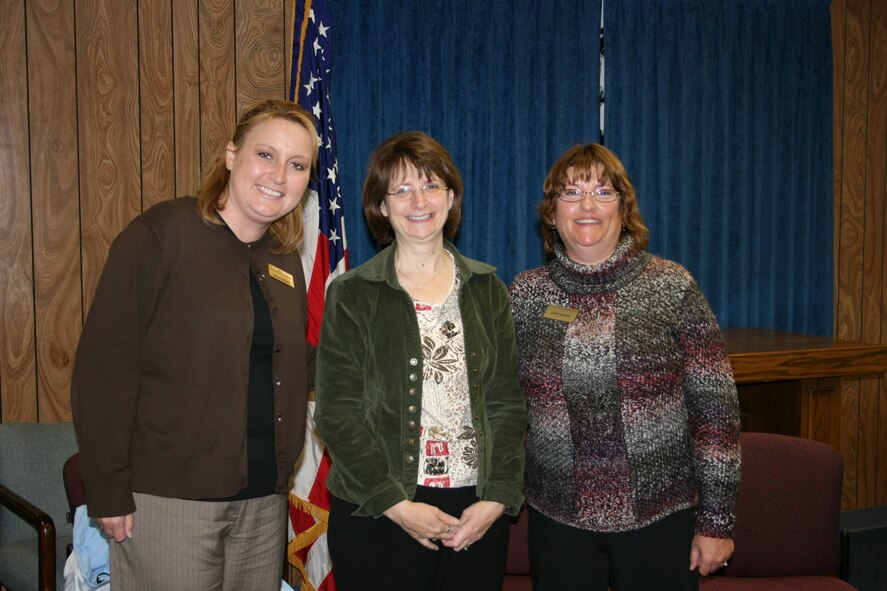 Kelli Johnson, Family Readiness Group financial counselor, Kathy Fitzgerald, 131st Bomb Wing Family Program coordinator, Terri Brown, Military Family Life consultant, pose together during Brown's going away ceremony Oct. 17. Members from the 131st BW said goodbye to Brown after providing the base with a year and a half of service counseling members during hard times. (courtesy photo)