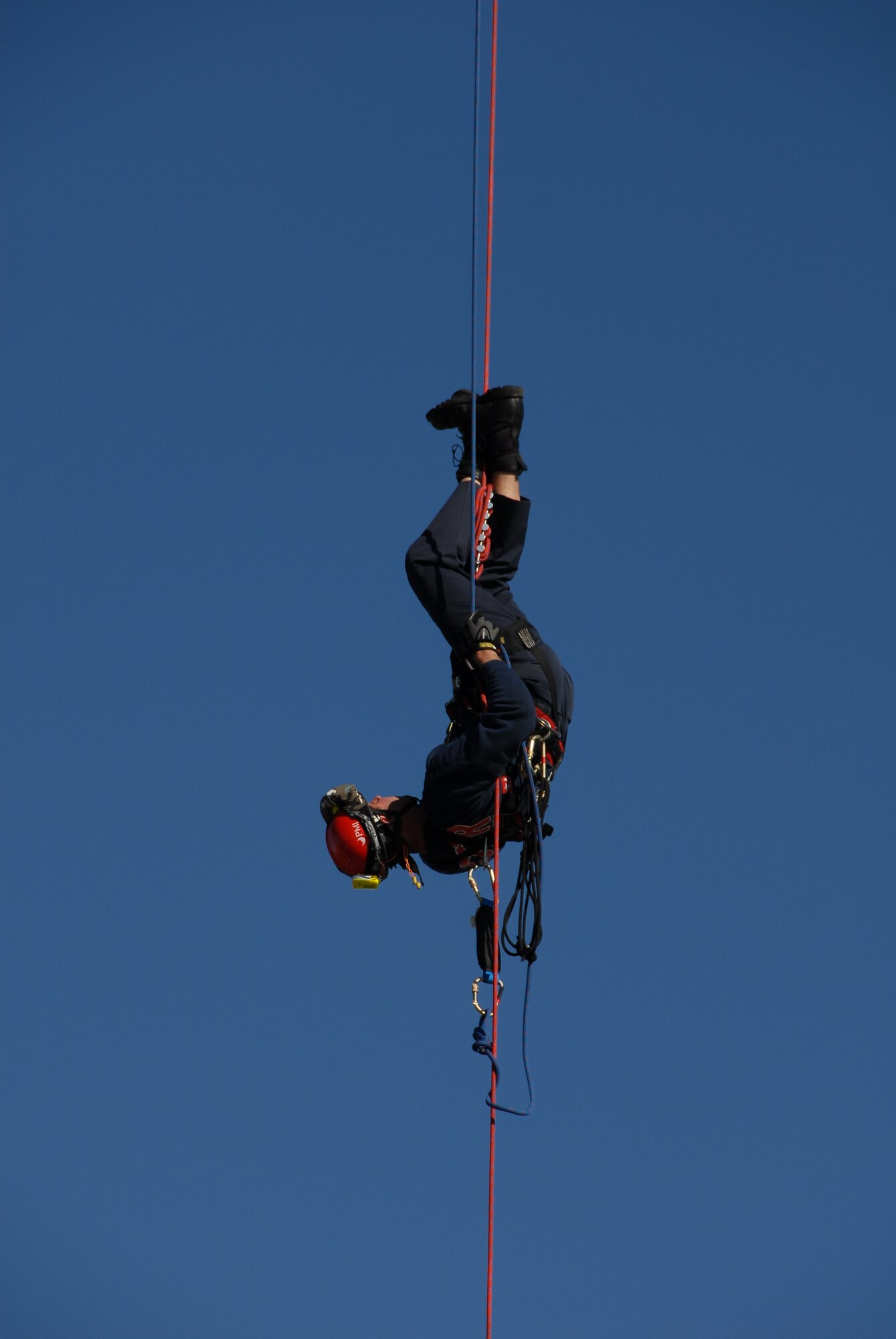 Senior Master Sgt. David Maupin, 231st Civil Engineer Flight, dangles upside down during a rappel demonstration done for servicemembers at Lambert International Airport Oct. 18 in honor of Fire Safety Month to show the members some of the local firefighters training. (Photo by Master Sgt. Mary-Dale Amison)