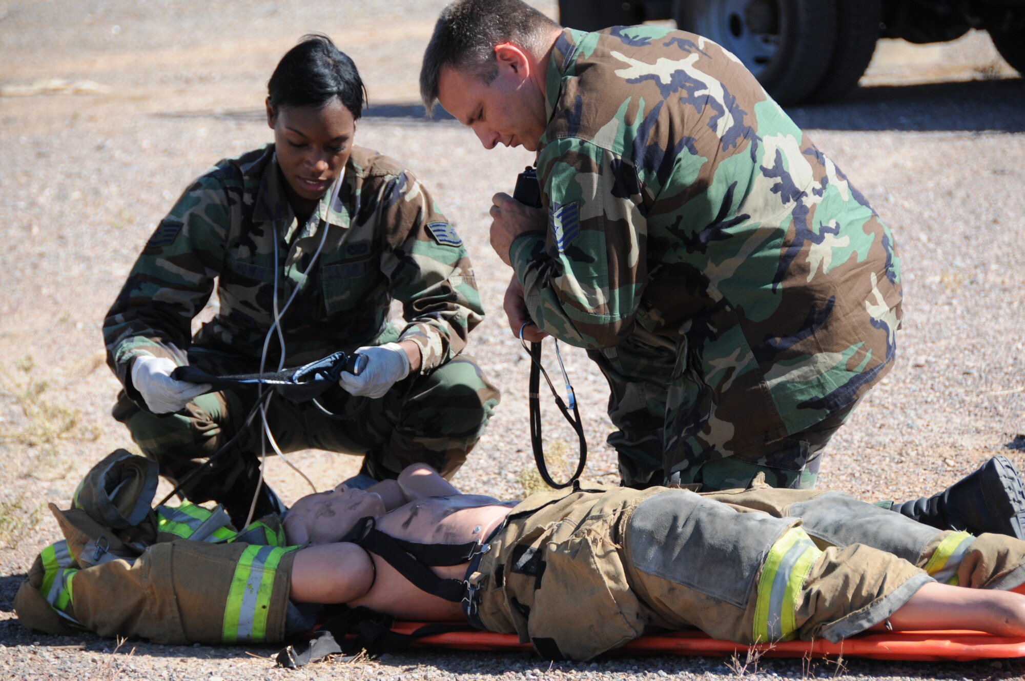 Staff Sgt. Nikela Howze and Tech. Sgt. Ken Heng, 944th Civil Engineer Squadron firefighters, perform a medical evaluation during a structural fire exercise Oct. 17. (U.S. Air Force photo/Tech. Sgt. Susan Stout)