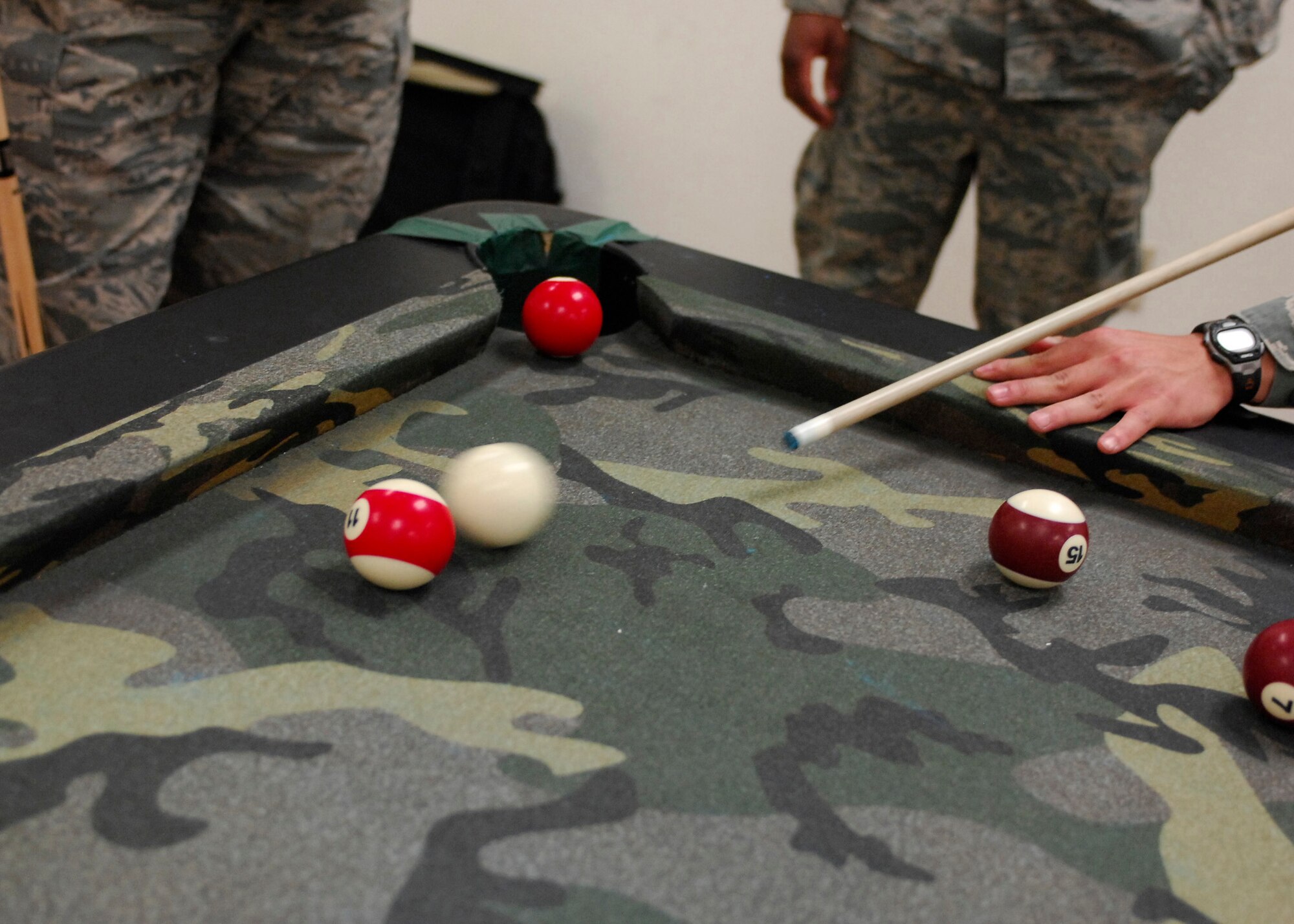 BAGRAM AIRFIELD, Afghanistan -- U.S. Coalition forces deployed here spend time at Morale Welfare and Recreation buildings checking their e-mail, playing card games or hanging out. The sole pool table is always in hot demand, with people waiting in lines to play game after game.  
(U.S. Air Force photo / Senior Airman Susan Tracy)
