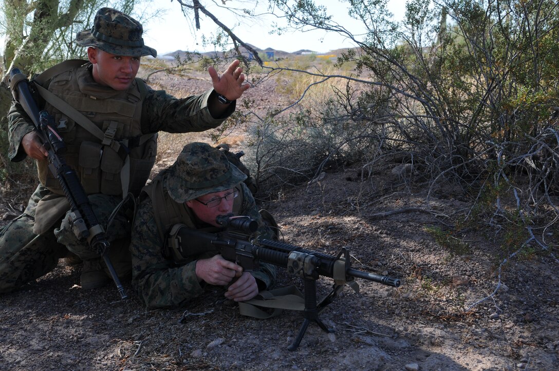 Marines from Headquarters and Service Company, 1st Battalion, 2nd Marine Regiment, practice establishing fields of fire during infantry tactics training at Graze Range at the U.S. Army Yuma Proving Ground in Arizona, Oct. 18, 2009. Comprised of Marines with noninfantry specialties, the Camp Lejeune, N.C.-based company is preparing to operate as an infantry company during their upcoming deployment to Afghanistan in the spring of 2010.