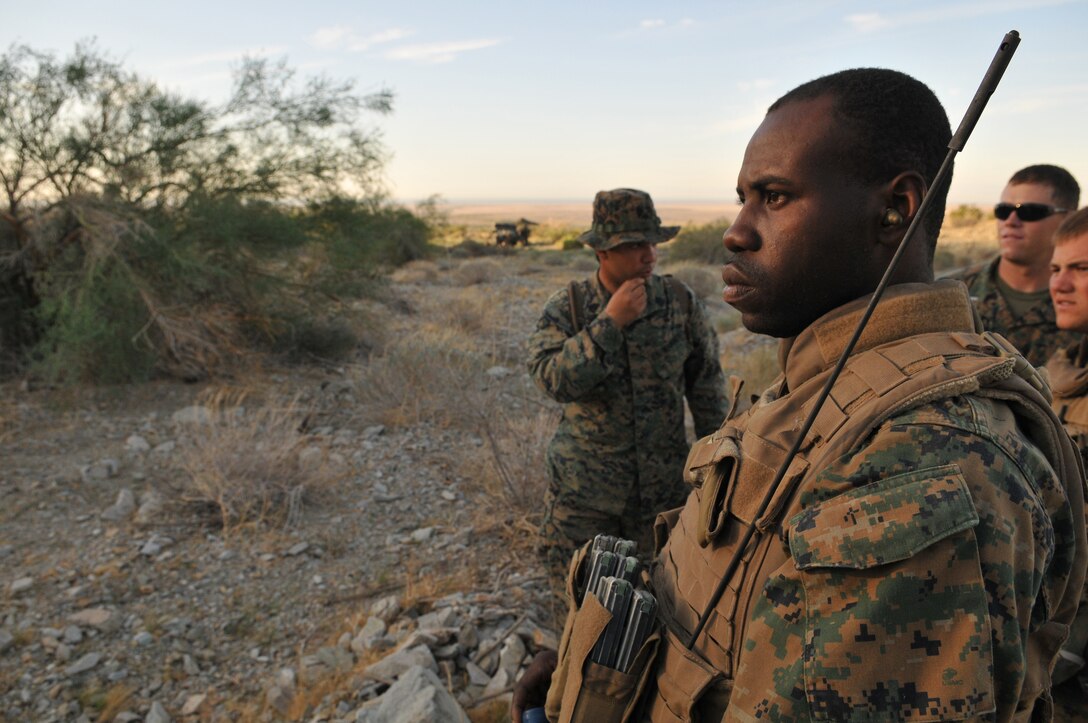 Sgt. Nixon Jean, 3rd platoon sergeant of Company A, 1st Battalion, 2nd Marine Regiment, watches as one of his fire teams begins their live-fire ambush and reaction drill at the Camp Billy Machen desert warfare training facility in the Chocolate Mountain Aerial Gunnery Range in California Oct. 18, 2009. The Camp Lejeune, N.C.-based company spent three days at the camp, making use of its rocky, mountainous terrain to prepare for an upcoming deployment to Afghanistan early next year. Along with ambush and immediate action drills, the Marines also executed live-fire combat patrols of the area. Jean, 27, is a native of Fort Lauderdale, Fla.