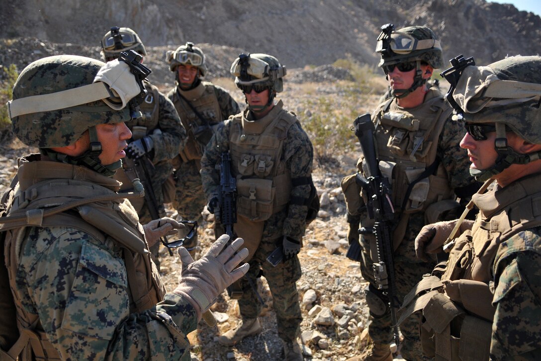 Gunnery Sgt. Carlos Pagan, weapons platoon sergeant of Company A, 1st Battalion, 2nd Marine Regiment, reviews a fire team’s performance after a live-fire ambush and reaction drill at the Camp Billy Machen desert warfare training facility in the Chocolate Mountain Aerial Gunnery Range in California Oct. 18, 2009. The Camp Lejeune, N.C.-based company spent three days at the camp, making use of its rocky, mountainous terrain to prepare for an upcoming deployment to Afghanistan early next year. Pagan, 38, is a native of Hartford, Conn.
