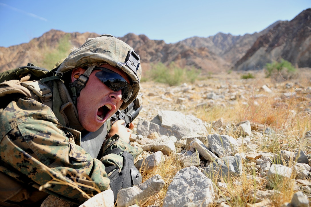 Lance Cpl. Jacob Carter, a fire team leader with Company A, 1st Battalion, 2nd Marine Regiment, shouts commands to his Marines as they advance on targets during a live-fire ambush and reaction drill at the Camp Billy Machen desert warfare training facility in the Chocolate Mountain Aerial Gunnery Range in California Oct. 18, 2009. The Camp Lejeune, N.C.-based company spent three days at the camp, making use of its rocky, mountainous terrain to prepare for an upcoming deployment to Afghanistan early next year, holding classes and executing live-fire immediate action drills and combat patrols. The live-fire drills were all carried out without dry runs, creating an environment of uncertainty for the Marines to train in. “When you do a dry run, you can better scheme your maneuvers,” said Carter, 22, of Lakeland, Fla. “But this gets team leaders to think on the fly and prepares us for combat. The harder we train here, the easier things will be in country.”
